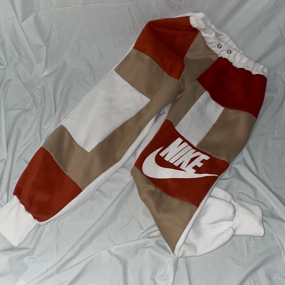 these nike sweats are a medium, muir color with brown, burgundy, and white
